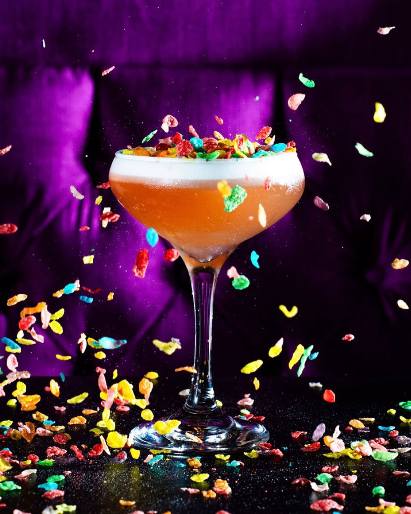 cocktail on table with flying confetti