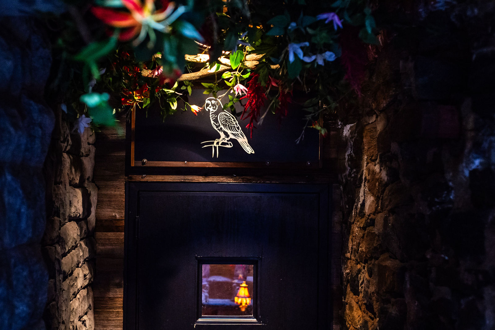 polly's entrance black door with flowers on the ceiling